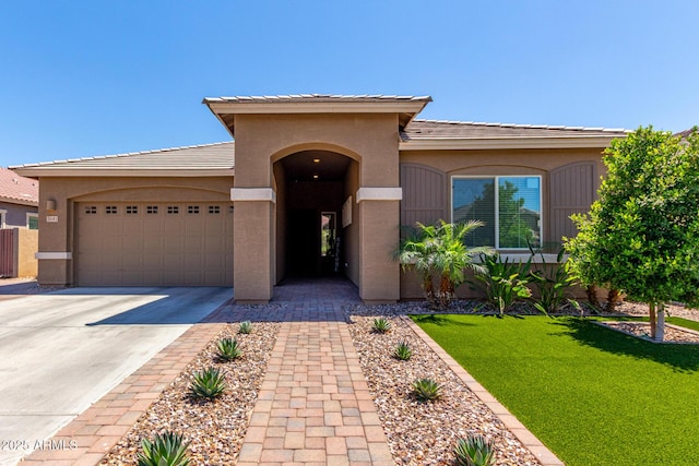 3081 E Desert Broom Pl, Chandler, AZ 85286 - mediterranean / spanish-style home with stucco siding, an attached garage, concrete driveway, and a front yard