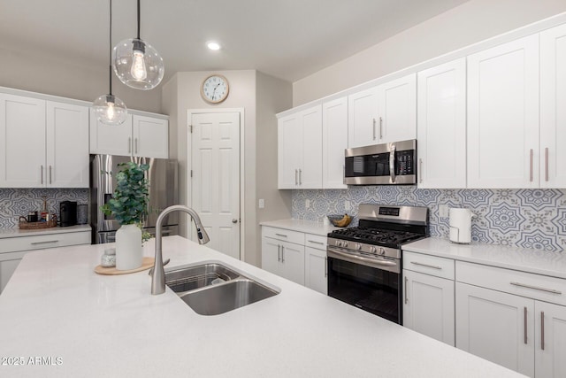 3081 E Desert Broom Pl, Chandler, AZ 85286 - kitchen with appliances with stainless steel finishes, a sink, decorative backsplash, light countertops, and decorative light fixtures