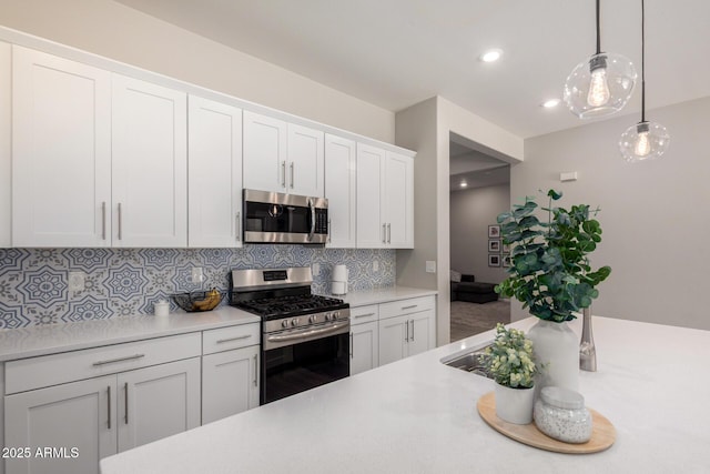 3081 E Desert Broom Pl, Chandler, AZ 85286 - kitchen featuring stainless steel appliances, light countertops, decorative backsplash, white cabinetry, and recessed lighting