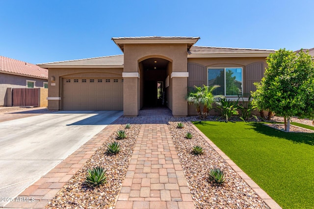 3081 E Desert Broom Pl, Chandler, AZ 85286 - mediterranean / spanish house featuring concrete driveway, an attached garage, stucco siding, and a front lawn