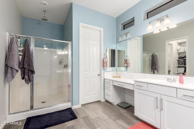 3081 E Desert Broom Pl, Chandler, AZ 85286 - bathroom featuring a stall shower, wood finished floors, and vanity