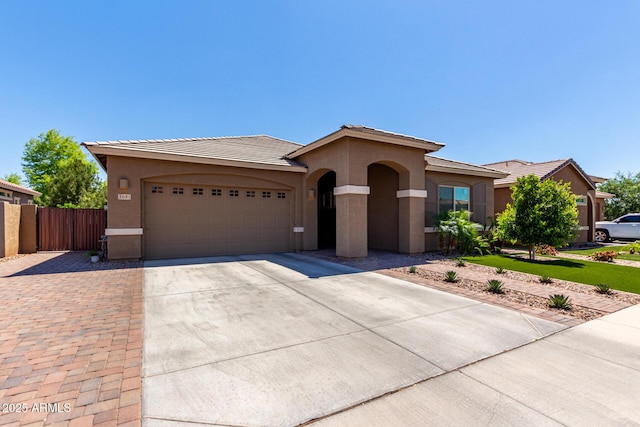 3081 E Desert Broom Pl, Chandler, AZ 85286 - view of front facade featuring concrete driveway, stucco siding, an attached garage, and fence