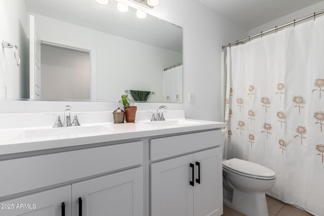 bathroom with tile patterned floors, vanity, and toilet