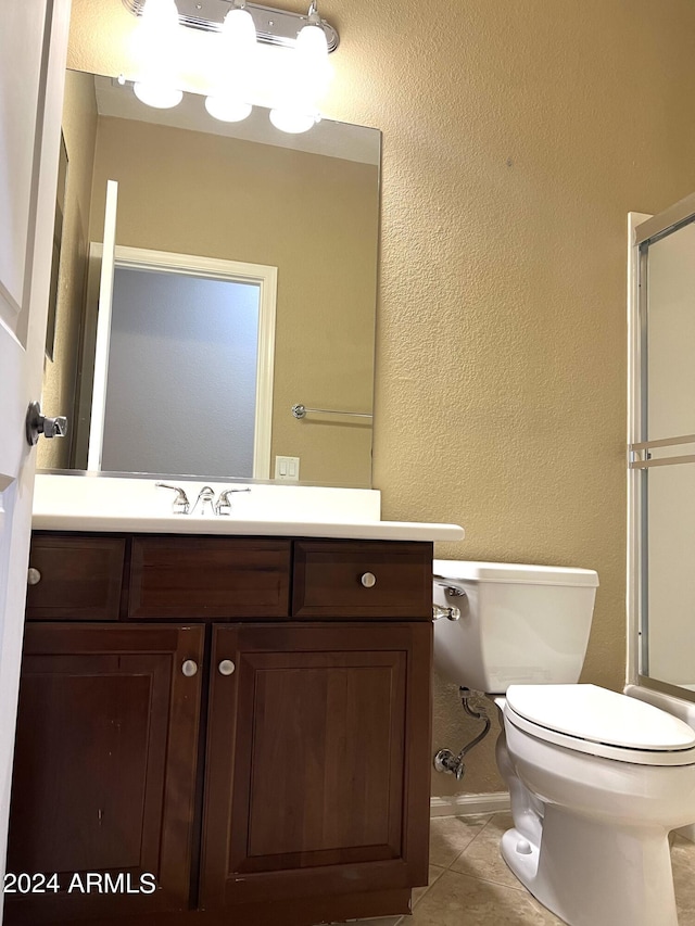 bathroom featuring toilet, tile patterned floors, and vanity