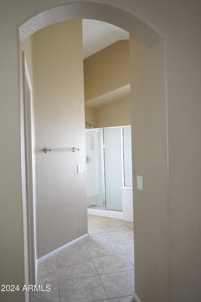 hall with light tile patterned floors