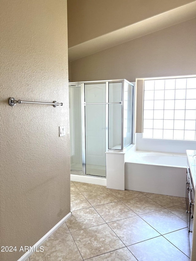 bathroom with plus walk in shower, vanity, and tile patterned flooring