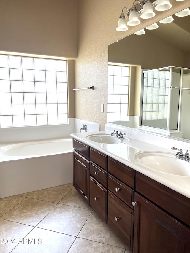 bathroom with vanity, tile patterned flooring, and plus walk in shower