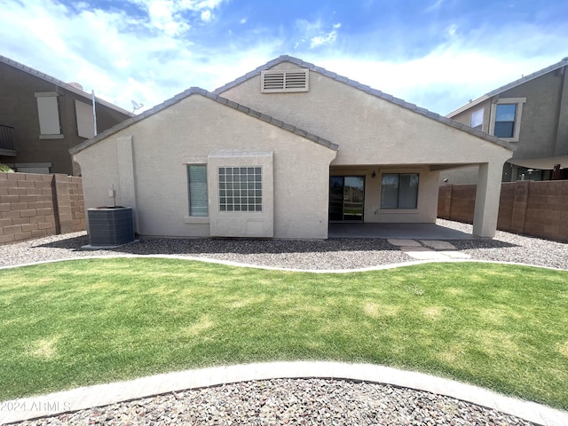 back of property featuring central air condition unit, a yard, and a patio