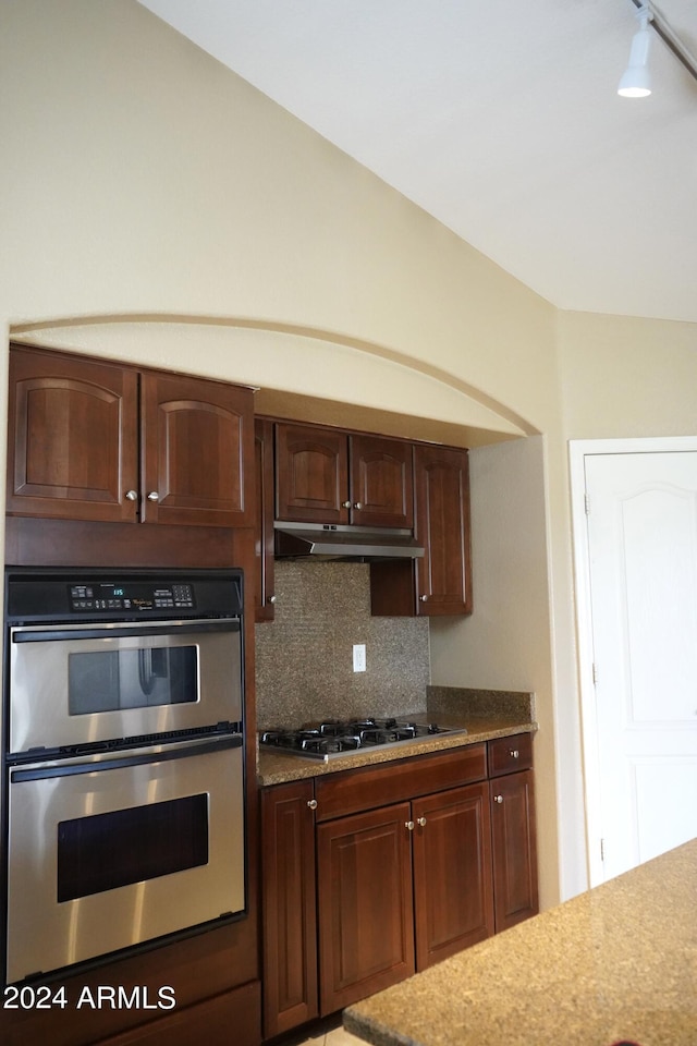 kitchen featuring gas stovetop, stainless steel double oven, and tasteful backsplash