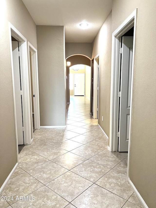 hallway with light tile patterned floors