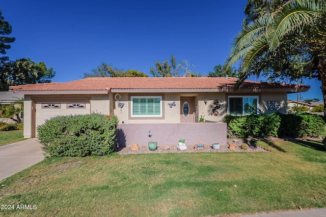 view of front of house with a front yard and a garage