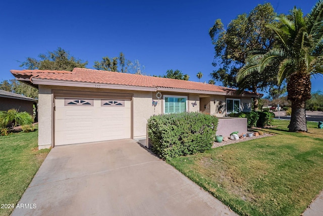 ranch-style home featuring a front yard and a garage