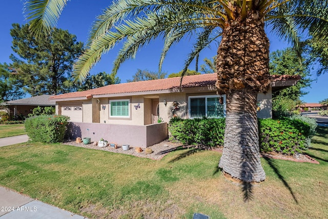 view of front of home featuring a front lawn and a garage