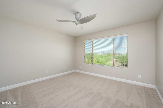 spare room with baseboards, carpet floors, and ceiling fan