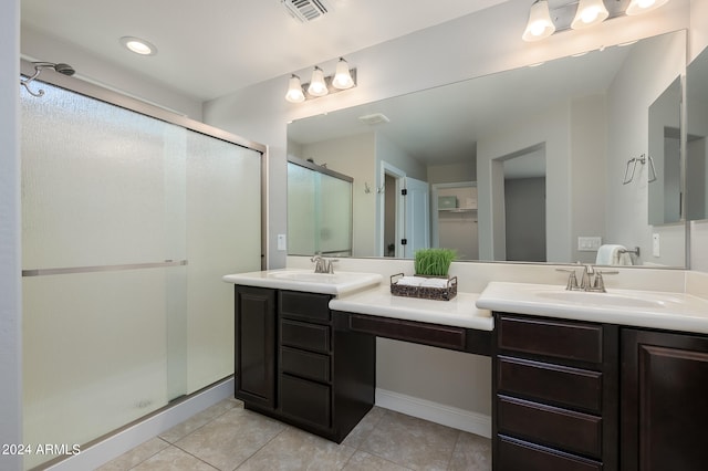 bathroom featuring tile patterned flooring, vanity, and walk in shower