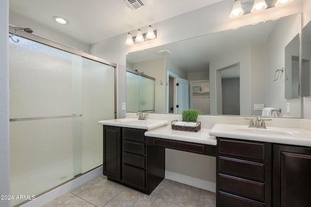 full bath featuring tile patterned flooring, double vanity, a shower stall, and visible vents