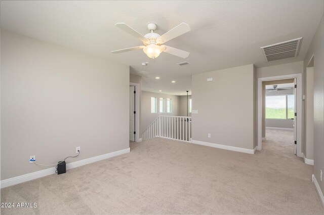 carpeted empty room featuring ceiling fan