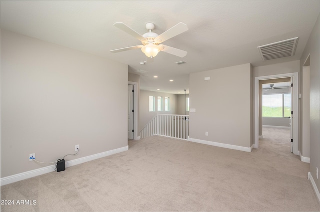 unfurnished room featuring plenty of natural light, baseboards, visible vents, and ceiling fan
