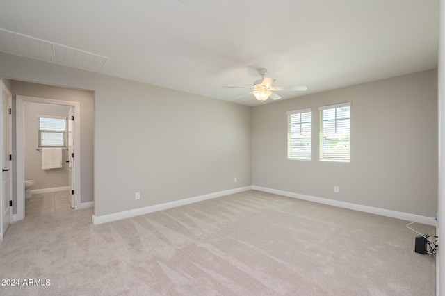 unfurnished bedroom featuring light colored carpet, baseboards, and a ceiling fan