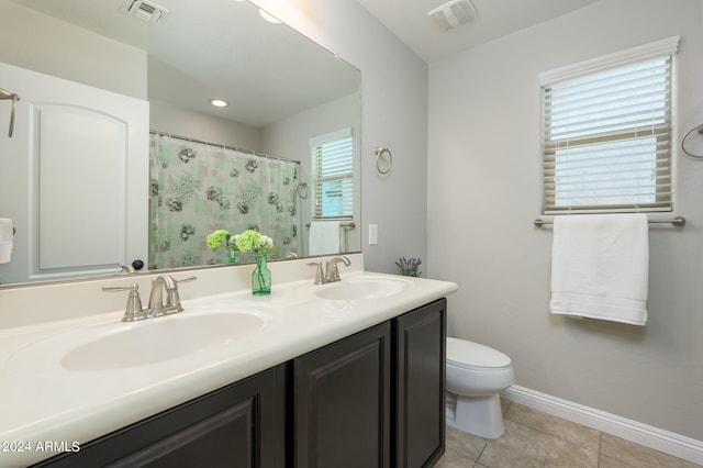 bathroom with toilet, tile patterned flooring, and vanity