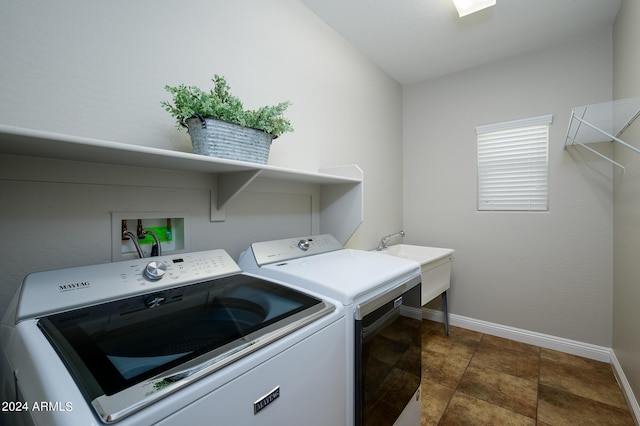 laundry area featuring washer and clothes dryer, baseboards, and laundry area