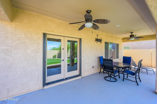 view of patio featuring french doors, outdoor dining area, fence, and ceiling fan