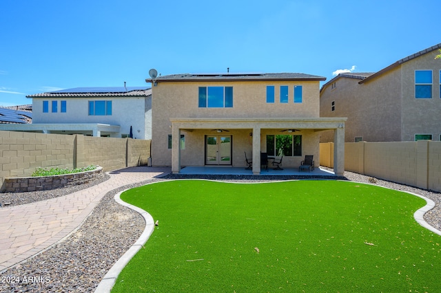 back of house featuring a patio area and a yard