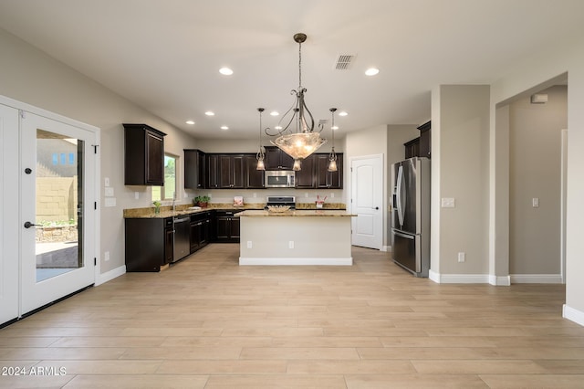 kitchen featuring light wood-type flooring, recessed lighting, appliances with stainless steel finishes, and a kitchen island