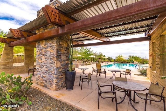 view of patio / terrace with a pergola and a community pool