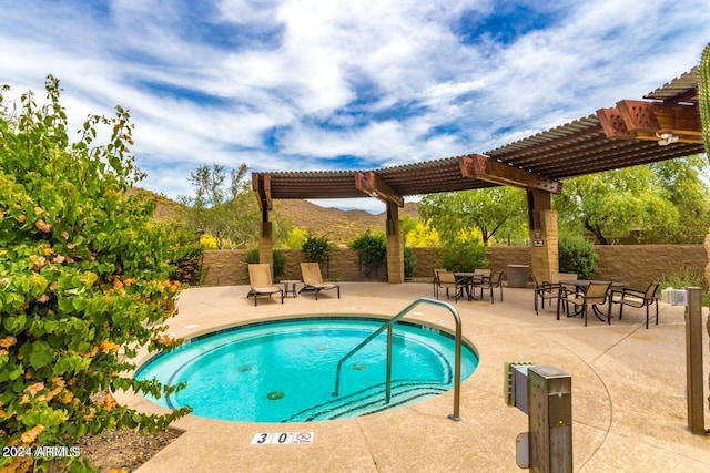 view of swimming pool with a pergola, fence, a patio area, and a community hot tub