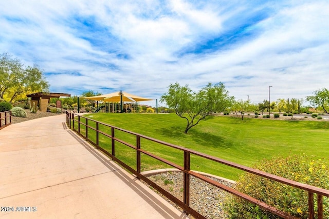 surrounding community featuring playground community and a yard