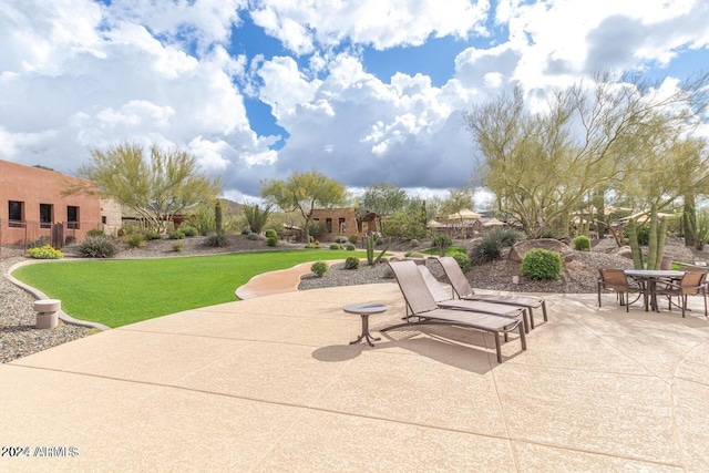 view of home's community featuring a lawn and a patio