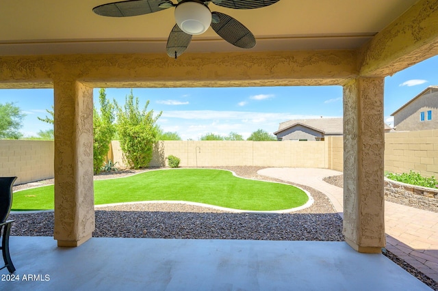 view of patio with a fenced backyard and a ceiling fan