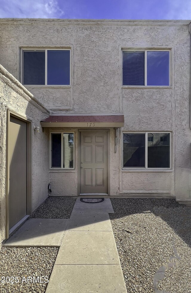 property entrance featuring stucco siding