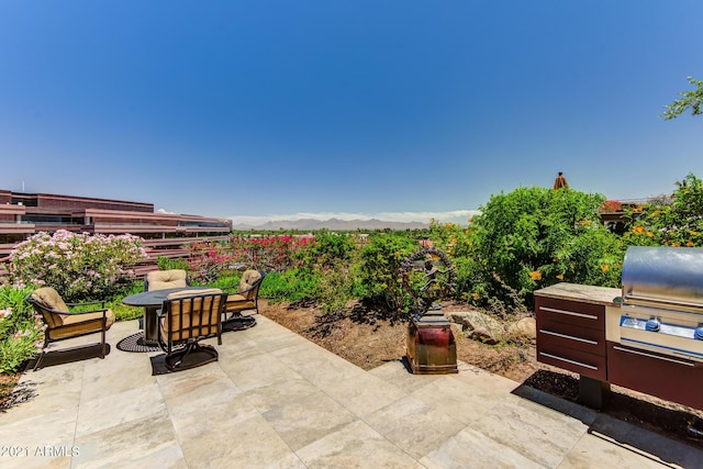 7161 E Rancho Vista Dr Unit 6001, Scottsdale, AZ 85251 - view of patio with a mountain view and area for grilling