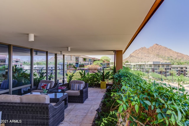 exterior space featuring a mountain view, an outdoor living space, and a patio