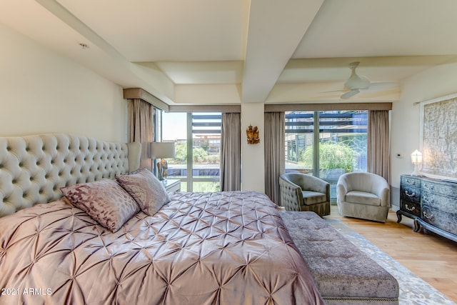 bedroom featuring multiple windows, light hardwood / wood-style floors, and ceiling fan