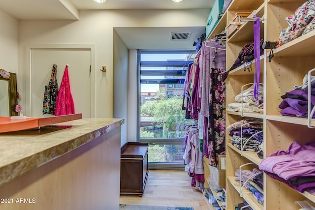 spacious closet with light hardwood / wood-style floors