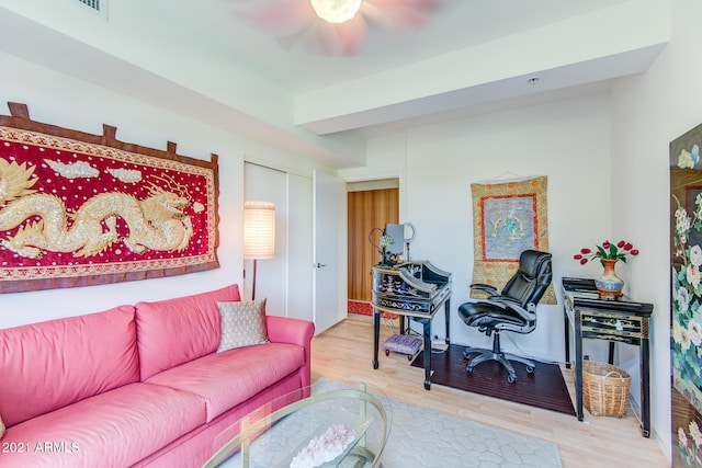 living room with ceiling fan and hardwood / wood-style flooring