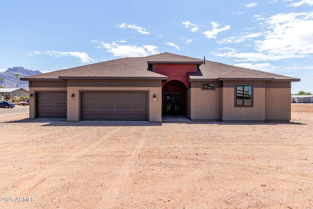 2009 S Raindance Rd, Apache Junction, AZ 85119 - view of front facade featuring dirt driveway, an attached garage, roof with shingles, and a mountain view
