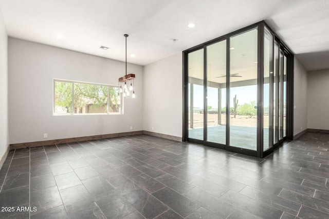 2009 S Raindance Rd, Apache Junction, AZ 85119 - unfurnished room with a wall of windows and recessed lighting