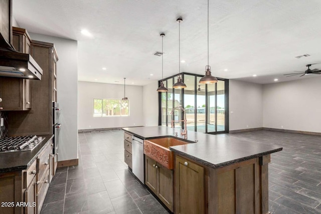2009 S Raindance Rd, Apache Junction, AZ 85119 - kitchen featuring appliances with stainless steel finishes, dark countertops, wall chimney exhaust hood, ceiling fan, and open floor plan