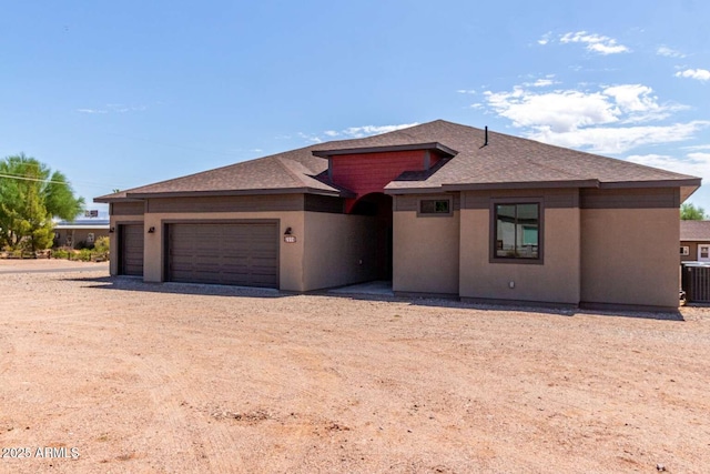 2009 S Raindance Rd, Apache Junction, AZ 85119 - prairie-style house featuring roof with shingles, an attached garage, driveway, and stucco siding