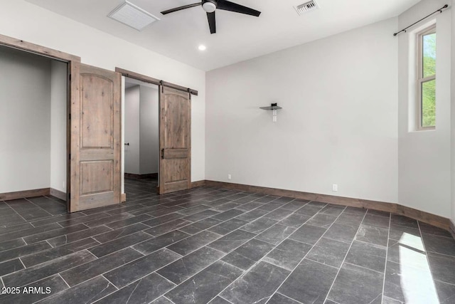 2009 S Raindance Rd, Apache Junction, AZ 85119 - unfurnished bedroom featuring a barn door, recessed lighting, and a ceiling fan