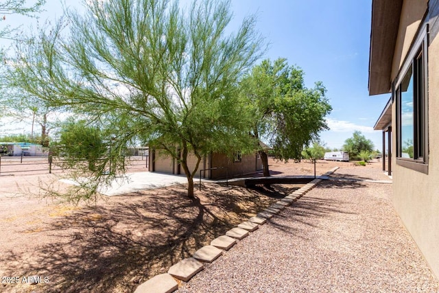 2009 S Raindance Rd, Apache Junction, AZ 85119 - view of yard featuring a garage and driveway