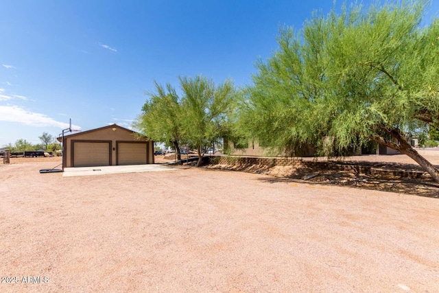 2009 S Raindance Rd, Apache Junction, AZ 85119 - view of yard featuring a detached garage and an outbuilding