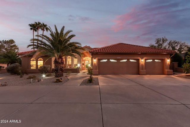 18649 E Mcdowell Mountain Dr, Rio Verde, AZ 85263 - mediterranean / spanish-style home featuring a tiled roof, an attached garage, driveway, and stucco siding
