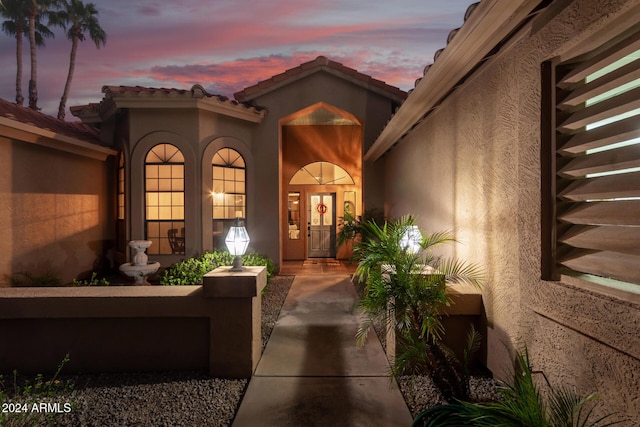 18649 E Mcdowell Mountain Dr, Rio Verde, AZ 85263 - exterior entry at dusk featuring a tiled roof and stucco siding