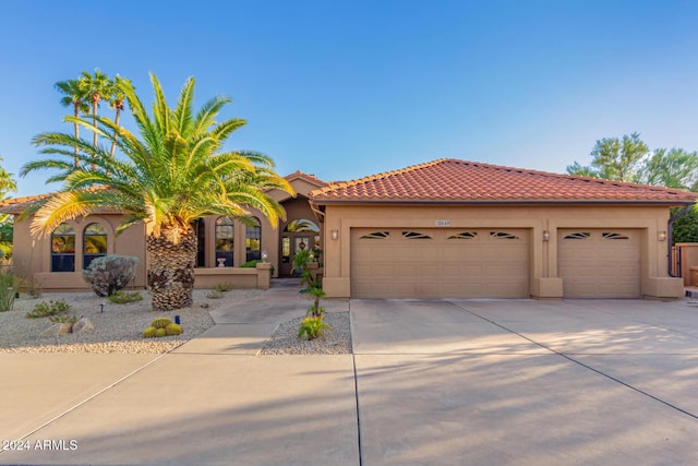 18649 E Mcdowell Mountain Dr, Rio Verde, AZ 85263 - mediterranean / spanish-style house featuring a garage, stucco siding, a tiled roof, and concrete driveway
