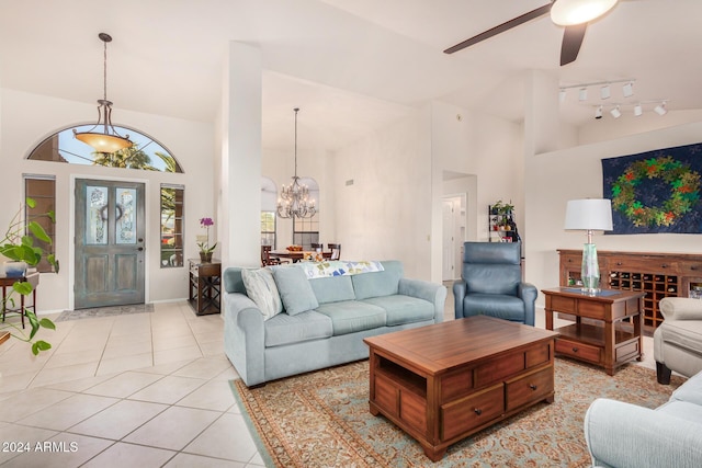 18649 E Mcdowell Mountain Dr, Rio Verde, AZ 85263 - living area featuring baseboards, high vaulted ceiling, light tile patterned floors, and ceiling fan with notable chandelier